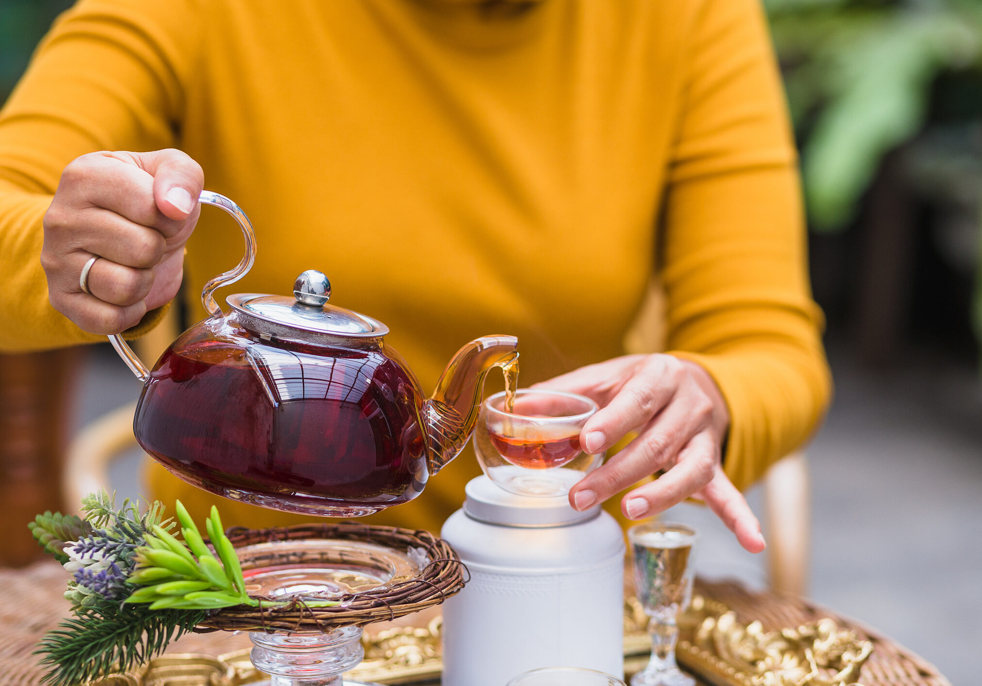 Pouring tea from glass teapot