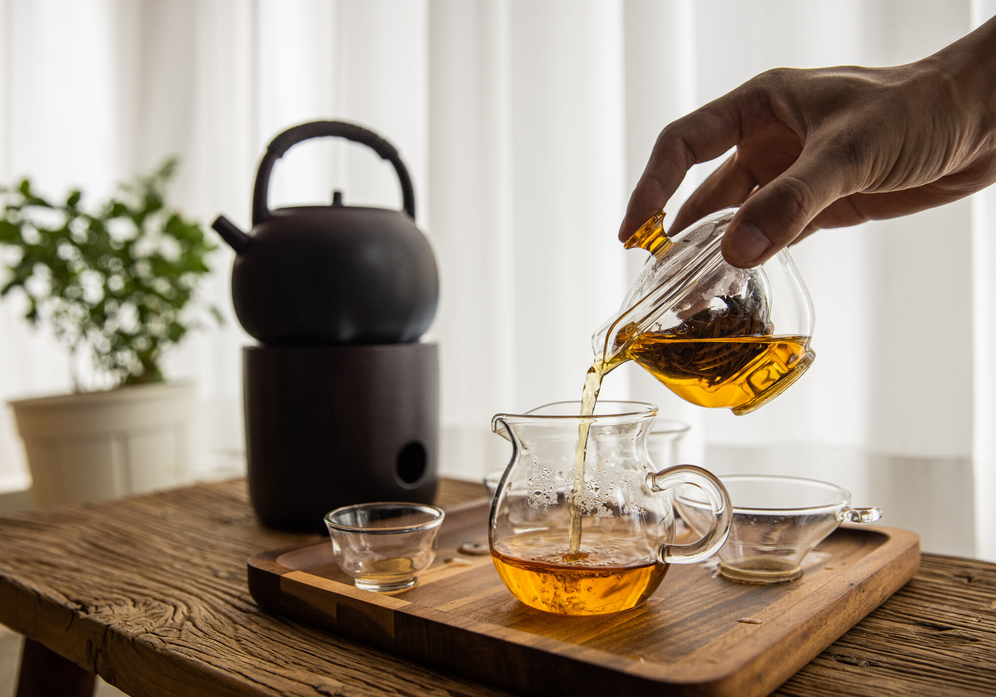 Tea being served on wooden table.