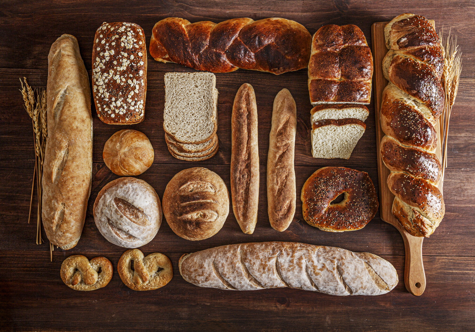 Assortment of bread on rustic wooden table.